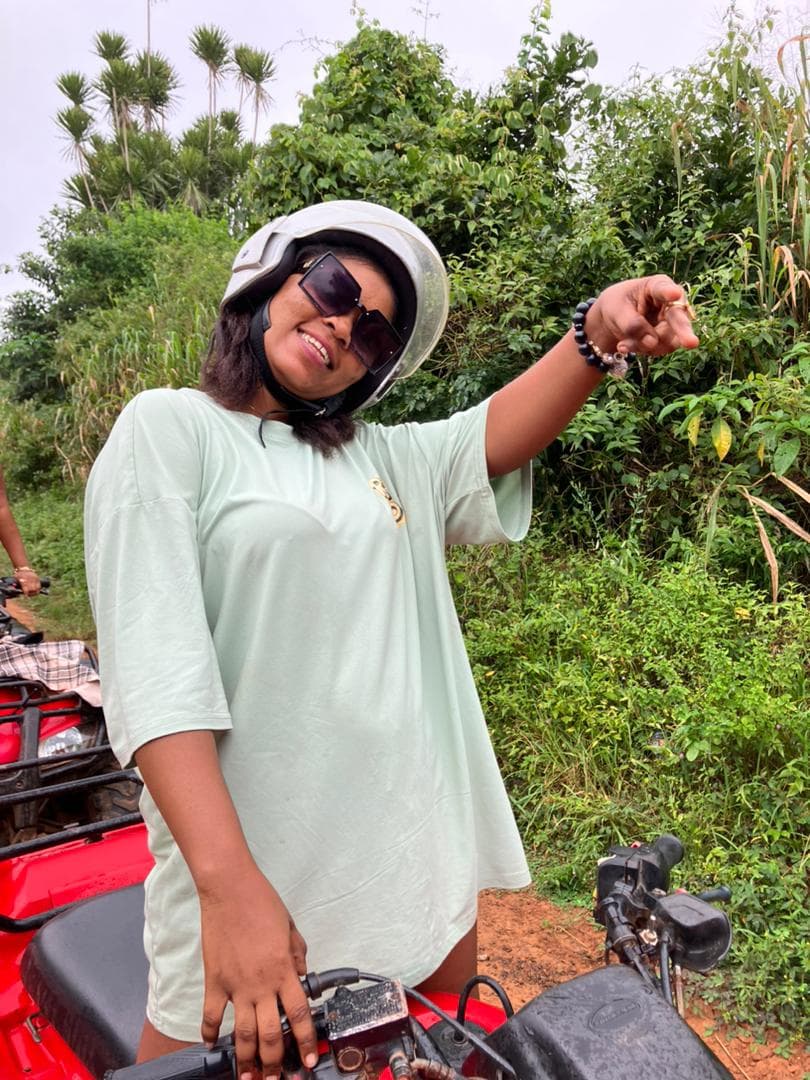 a lady with a helment on a quad bike