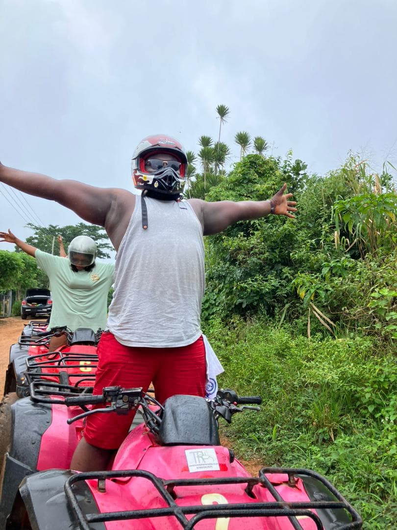 two people, each on a quad bike